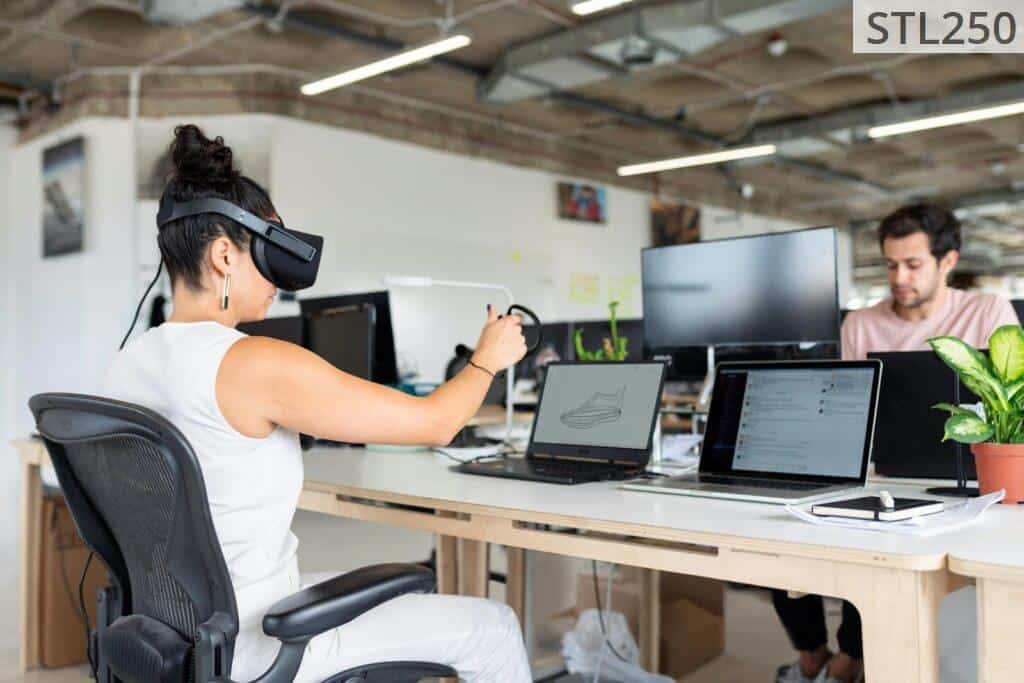 Woman Using Laptop Computer With VR Headset