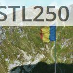 Romanian flag waves atop a scenic mountain landscape under a clear blue sky.