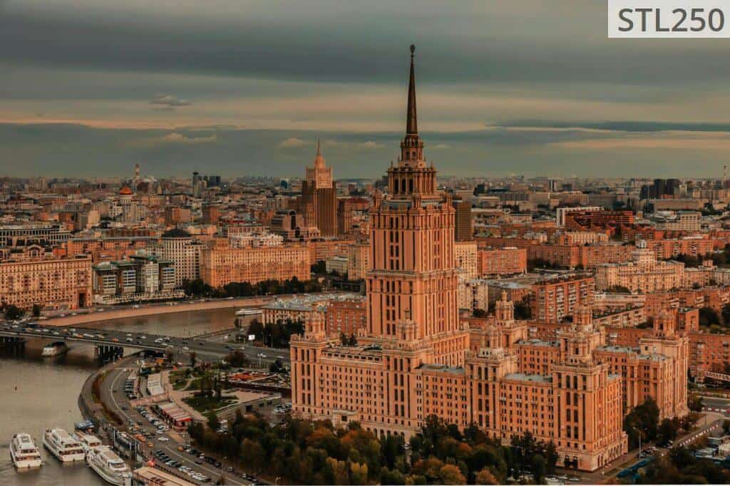 Stunning aerial view of Moscow cityscape featuring iconic building and river at dusk.