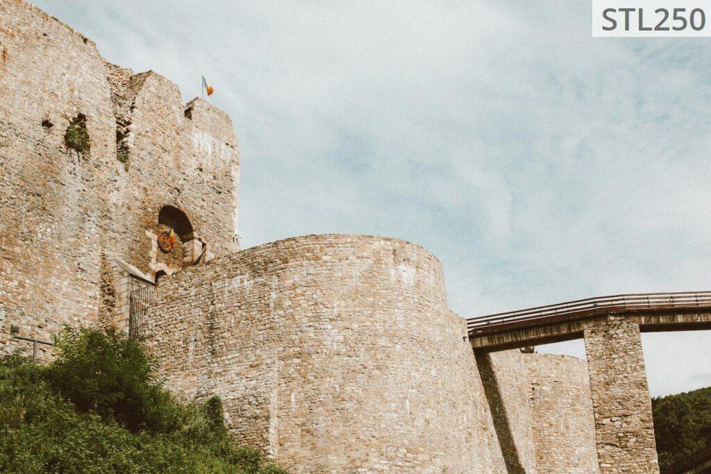 Explore the ancient stone walls of Neamt Citadel under a clear blue sky.