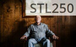 man sitting on armchair beside photo frame
