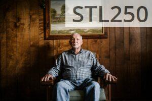 man sitting on armchair beside photo frame